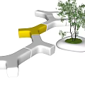 Modern Geometric Public Chair With White Yellow Sections And Small Tree In Public Space