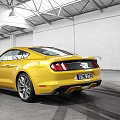 Yellow Ford Mustang Sports Car Parked In Modern Indoor Garage With Tire Tracks