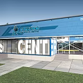 Basketball Gym Entrance With Blue Turnstiles Digital Screens And Reception Area
