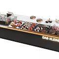 Modern Transparent Glass Display Cabinet Showcasing Assorted Chocolates And Desserts
