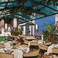 Elegant Restaurant Interior With Glass Roof Hanging Lanterns Wicker Chairs And White Tablecloths