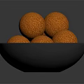 Crispy Orange Food Balls Served in Black Bowl with Crumbly Surface Texture