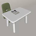 White Kids Table with Green Chair and Books for Children's Play Area