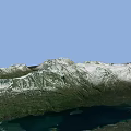 Mountainous Terrain With Snow Covered Peaks And Green Forested Valleys