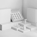 Minimalist Perfume Cosmetics Display Interior With White Stands And Glass Bottles