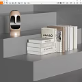 Gray Stepped Shelf Display With Various White Beige Books And Golden Humanoid Head Sculpture