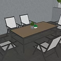 Outdoor Black Frame Dining Set With White Cushioned Chairs Brown Tabletop And Small Potted Plant