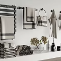 Gray Towels Hanging On Towel Rack And Folded On Bathroom Shelf With Decorative Items