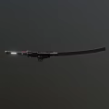 Shiny Black Long Sword With Red Handle Accents Floating On Dark Background