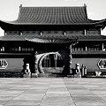 Ancient Chinese Architecture With Arched Gateway Red Walls Yellow Tiled Roof And Stone Lions