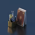 Pens in Brass Holder with Scissors Glasses and Red Decorated Book on Dark Blue Background
