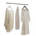 Light Colored Clothes In Various Styles With Lace Details Hanging On Hangers