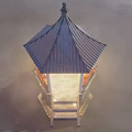 Scenic Pavilion With Blue Roof And White Pillars Over Calm Water Under Cloudy Sky