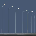 Illuminated Outdoor Street Lights Arranged In A Row Under Blue Sky