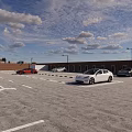 Parking Lot With White Car Yellow Lines Parking Sign And Brick Walls