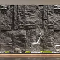 Serene Courtyard Garden With Natural Stone Wall Deer Ornament And Lush Plants