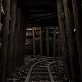 Mine Tunnel Roadway Infrastructure With Wooden Supports And Gravel Covered Rail Tracks