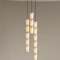 Modern Chandelier With Multiple Cylindrical White Shades Hanging Vertically In Design