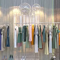 Colorful Dresses in Various Styles Hanging on Racks with High Heels and Decorative Lights