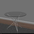 Round Transparent Glass Top Coffee Table With Metal Frame On Gray Rug And Sunlight Shadows