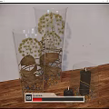 Decorative Ornament Set with Clear Glass Containers Dried Flowers Pebbles and Black Candles on Wooden Tabletop