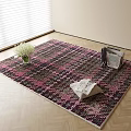 Black and Pink Plaid Square Rug with White Flowers and Magazines on Wooden Floor