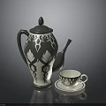Decorative Ceramic Teapot With Intricate Patterns And Matching Teacup On Saucer