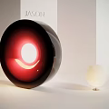 Modern Art Installation With Large Black Circular Design Red Glowing Crescent And Small White Sphere