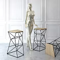 Modern Geometric Bar Stools With Metal Frames And Wooden Seats Against Brick Wall