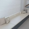 Elegant Light Colored Window Seat With Cushioned Surface Throw Pillows And Blinds