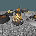 Patio Garden Various Round Fire Pits With Burning Flames On Gravel Surface And Wood Storage