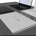 Three Modern Black And White Laptops With Blue Abstract Screens On Table