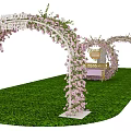 Decorative Event Archway Adorned With Pink Flowers Green Grass And Small Table