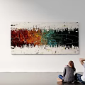 Vibrant Abstract Painting with Red Green Hues Viewed by Two People Sitting On White Wall