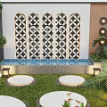 Modern Garden With Decorative Patterned Wall Water Feature Circular Seating And Green Plants
