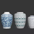 Lush Green Plants Displayed in Blue and White Patterned Vases on Dark Background