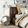 Double Bed With Leather Frame Linen Bedding Multiple Pillows Brick Wall And Metal Table Lamps
