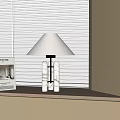 Modern Table Lamp with White Lampshade and Glass Base Near Window and Book