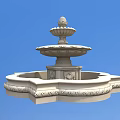White Multi Tiered Water Fountain With Decorative Base Against Blue Sky