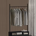 Metal Clothes Hanger with Light Beige Shirts and Tops in Wooden Room