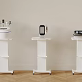 Three White Medical Devices Placed on Mobile Wheeled Stands in Clinical Environment