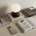 Modern Desktop Scene With Bulb Shaped Lamp Stacked Books Open Book Phone Notebook And Pen