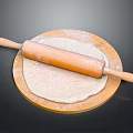 Wooden Rolling Pin on Round Board with Flour and Rolled Dough