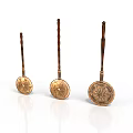 Three Copper Spoons With Wooden Handles And Decorative Patterns In Different Sizes