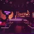 Modern Bar Interior With Purple Neon Lights Bar Counter High Stools Party Time Signage