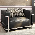 Black Leather Single Sofa With Metal Frame Houndstooth Pillow And Side Table Flower Vase