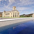 Large European Mansion With Reflecting Pool Blue Sky And Mountain View