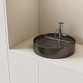 Modern Bathroom Round Black Washbasin With Silver Faucet And White Countertop