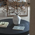 Black Textured Coffee Table With White Vase Books Glass Cup And Dried Twigs