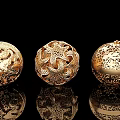 Intricate Carved Golden Spheres With Detailed Patterns On Black Background Reflections